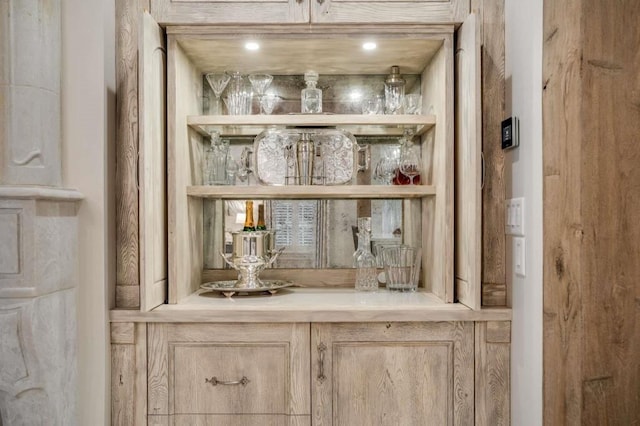 bar featuring light brown cabinetry