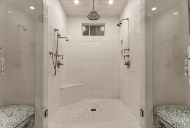 bathroom with a shower with door