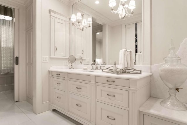 bathroom featuring an inviting chandelier, vanity, crown molding, and tile patterned floors