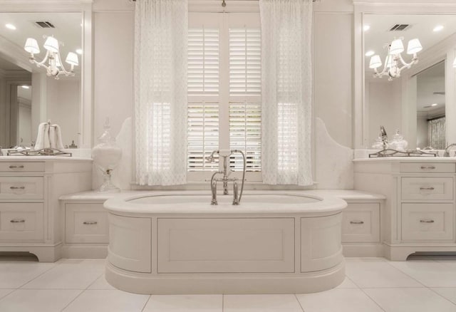 bathroom featuring tile patterned flooring, vanity, and a washtub