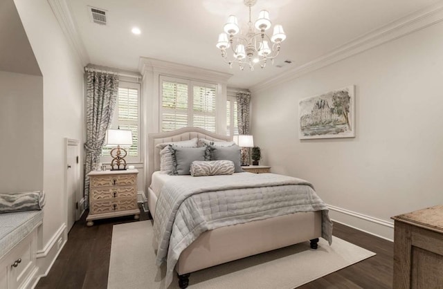 bedroom featuring ornamental molding, dark hardwood / wood-style floors, and a chandelier