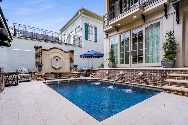 view of pool with a patio and french doors