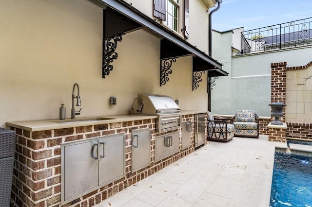 view of patio / terrace with area for grilling, sink, and a grill