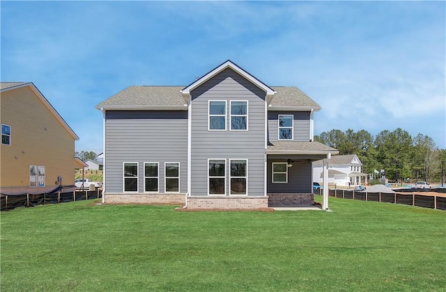 rear view of property with a yard