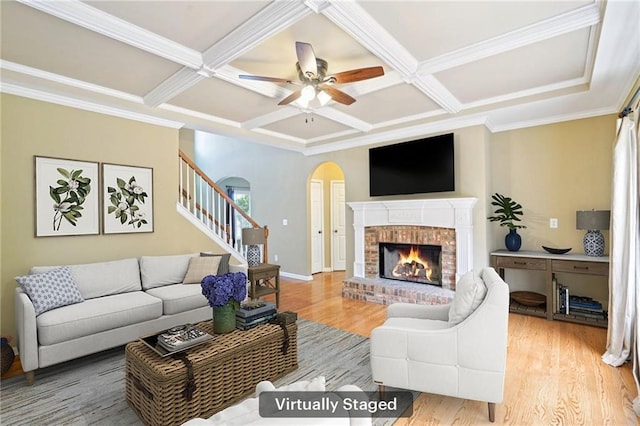 2359 Saint Kennedy Ln, Buford, GA 30518 - living area featuring coffered ceiling, wood finished floors, stairway, a brick fireplace, and arched walkways