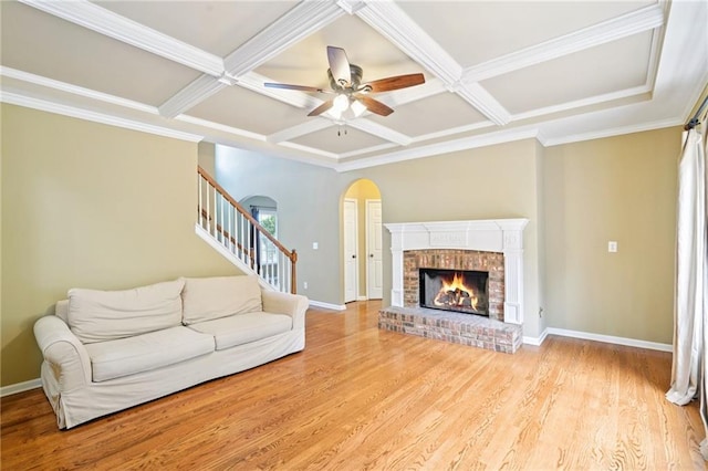 2359 Saint Kennedy Ln, Buford, GA 30518 - living room with coffered ceiling, light wood finished floors, a brick fireplace, ceiling fan, and stairway