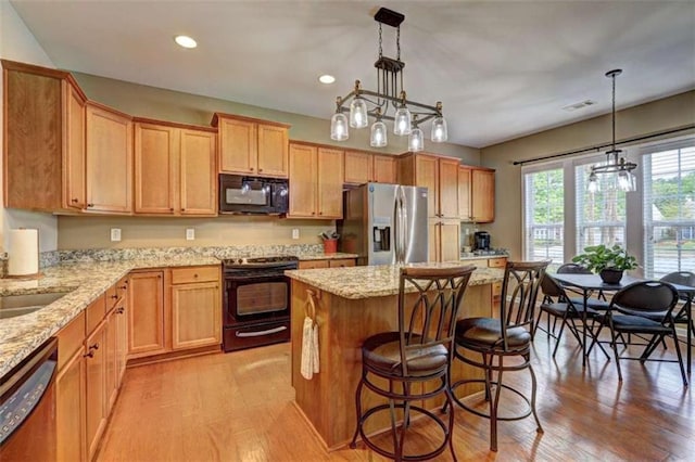 802 Dusky Sap Ct, Griffin, GA 30223 - kitchen with black appliances, light wood-style flooring, recessed lighting, a chandelier, and a kitchen island