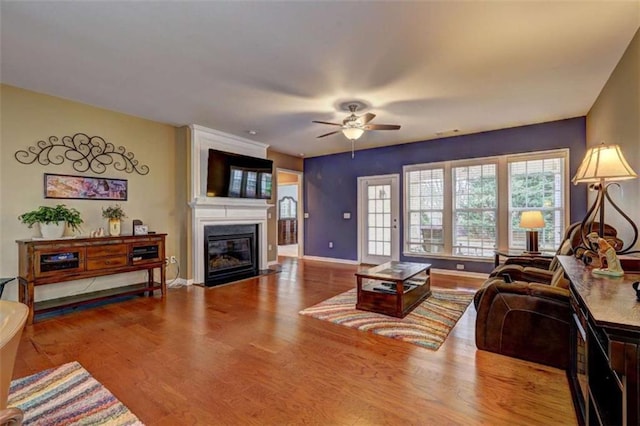 802 Dusky Sap Ct, Griffin, GA 30223 - living area with a fireplace with flush hearth, ceiling fan, and wood finished floors