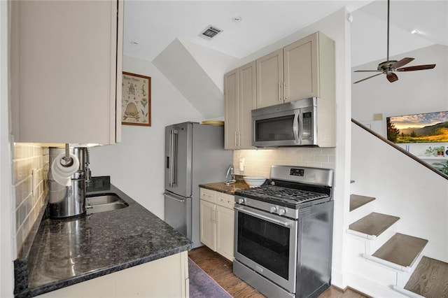 770 Barnett St NE, Atlanta, GA 30306 - kitchen with stainless steel appliances, backsplash, a ceiling fan, dark stone countertops, and lofted ceiling