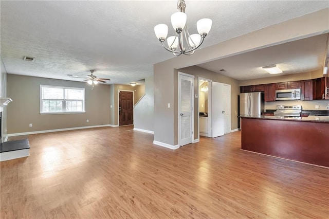 912 Third St, Stone Mountain, GA 30083 - unfurnished living room with a textured ceiling, light wood-style floors, baseboards, and a chandelier