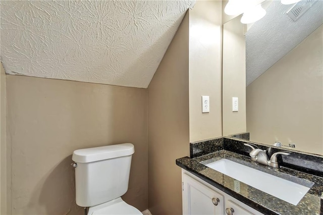 912 Third St, Stone Mountain, GA 30083 - half bath featuring vaulted ceiling, a textured ceiling, toilet, and vanity