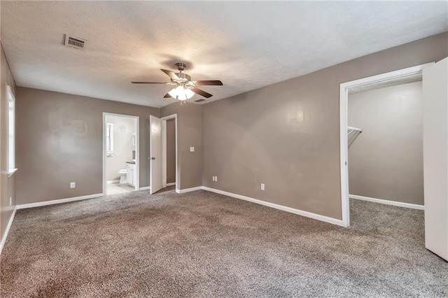 912 Third St, Stone Mountain, GA 30083 - unfurnished bedroom featuring carpet flooring, a walk in closet, baseboards, ensuite bath, and ceiling fan