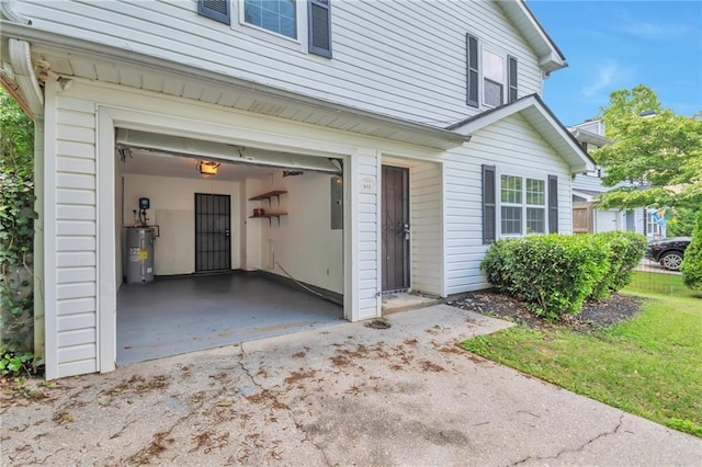 912 Third St, Stone Mountain, GA 30083 - property entrance featuring water heater, an attached garage, electric panel, and driveway