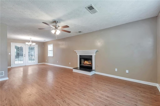 912 Third St, Stone Mountain, GA 30083 - unfurnished living room with wood finished floors, baseboards, a glass covered fireplace, ceiling fan, and a textured ceiling