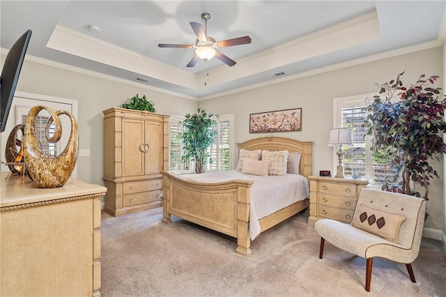 bedroom featuring a raised ceiling, crown molding, visible vents, and light carpet