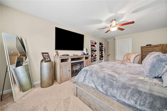 carpeted bedroom with baseboards and a ceiling fan