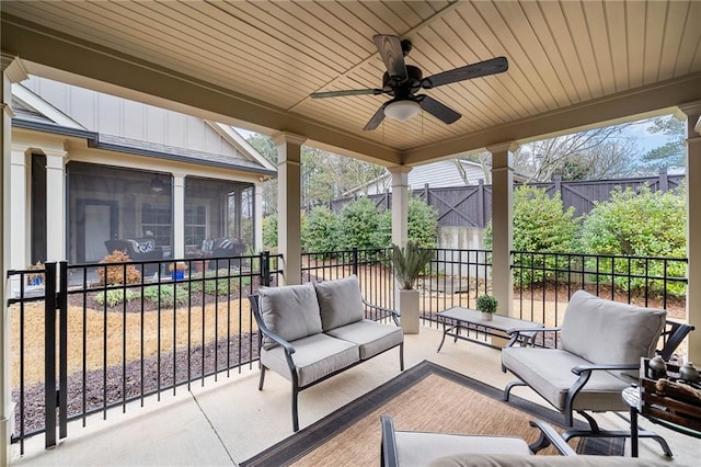 view of patio with an outdoor living space, a ceiling fan, and a sunroom