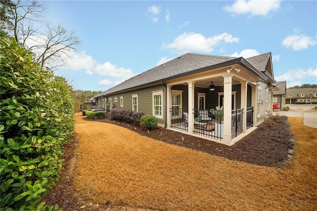 back of property with a patio area and a ceiling fan