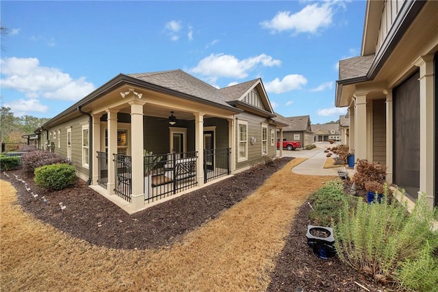 rear view of property featuring a patio, a ceiling fan, and a shingled roof