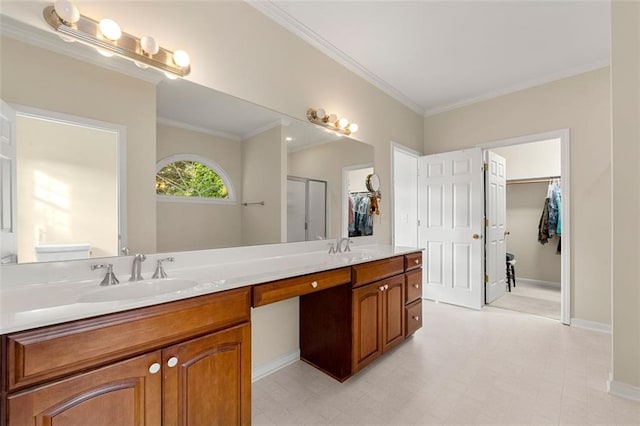 bathroom featuring walk in shower, vanity, and crown molding