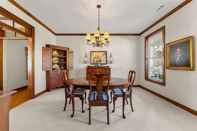 carpeted dining area with a chandelier and crown molding