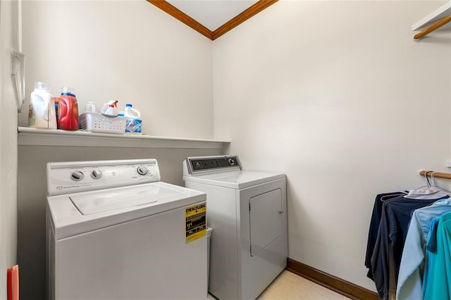 washroom featuring washing machine and dryer and ornamental molding