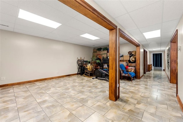 basement with a paneled ceiling