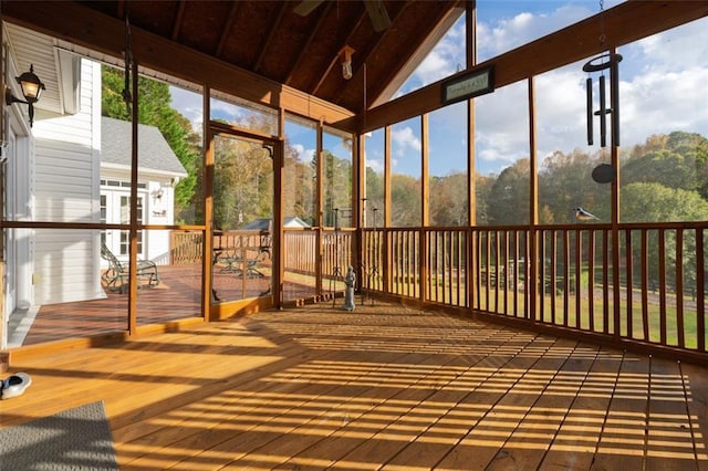 unfurnished sunroom featuring vaulted ceiling