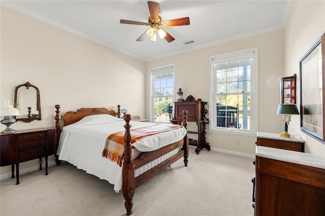 carpeted bedroom featuring ceiling fan and crown molding