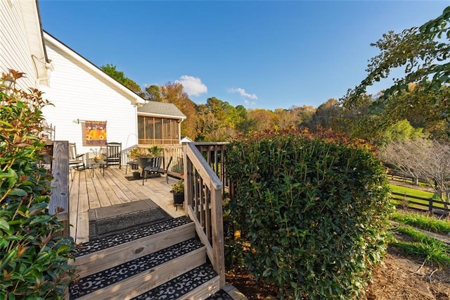 wooden deck featuring a sunroom