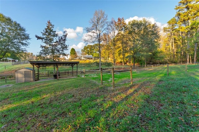 view of property's community featuring an outbuilding and a rural view