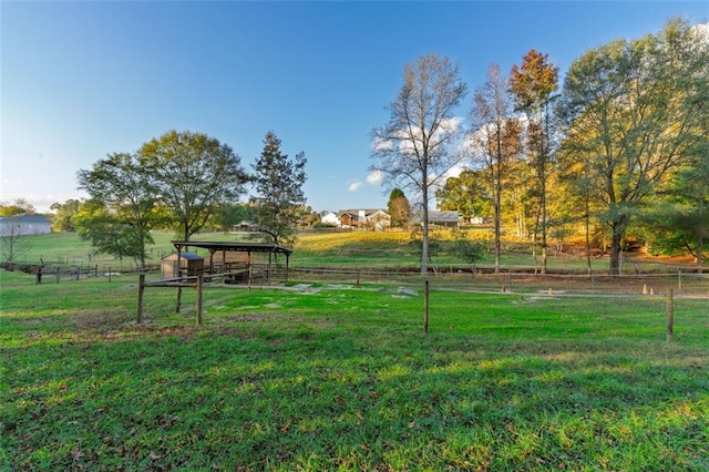 view of community with a lawn and a rural view