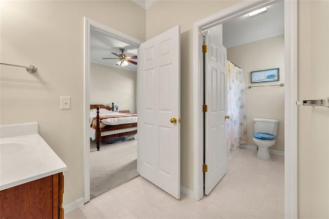 bathroom with ornamental molding, vanity, ceiling fan, and toilet