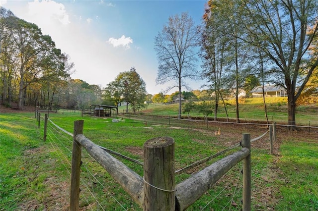 view of home's community featuring a rural view and a lawn