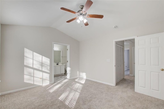 unfurnished room with ceiling fan, lofted ceiling, and light carpet