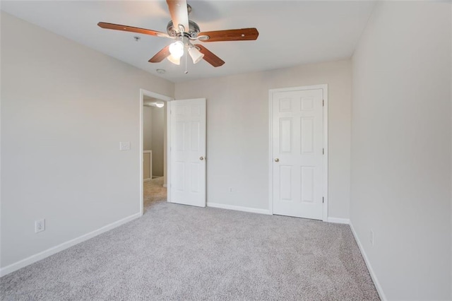 unfurnished bedroom featuring ceiling fan and light colored carpet