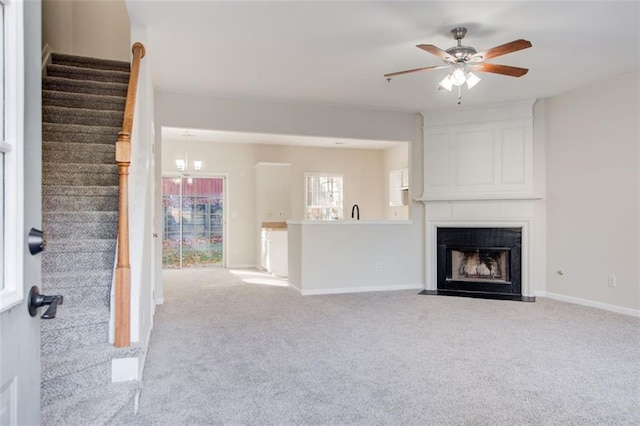 unfurnished living room featuring a fireplace, light carpet, and ceiling fan