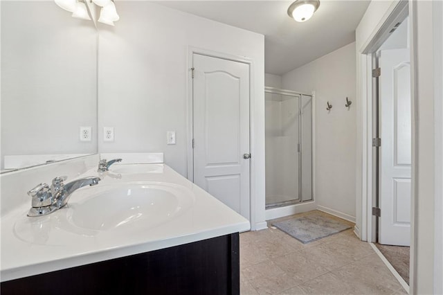 bathroom with a shower with shower door and vanity