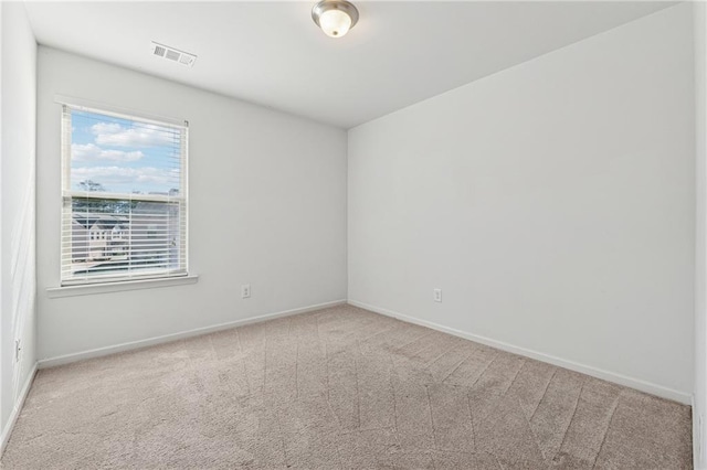 unfurnished room with light carpet