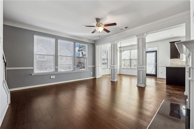 unfurnished living room with dark wood-type flooring, crown molding, and ceiling fan with notable chandelier