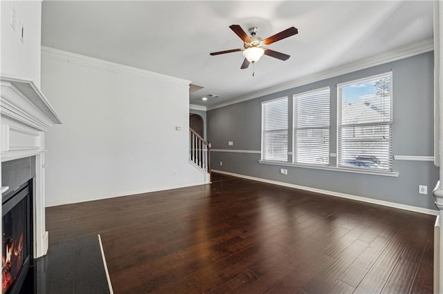 unfurnished living room with ceiling fan, dark hardwood / wood-style floors, and ornamental molding