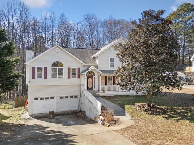 bi-level home featuring a porch and a garage