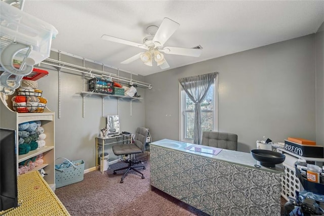 carpeted home office featuring ceiling fan