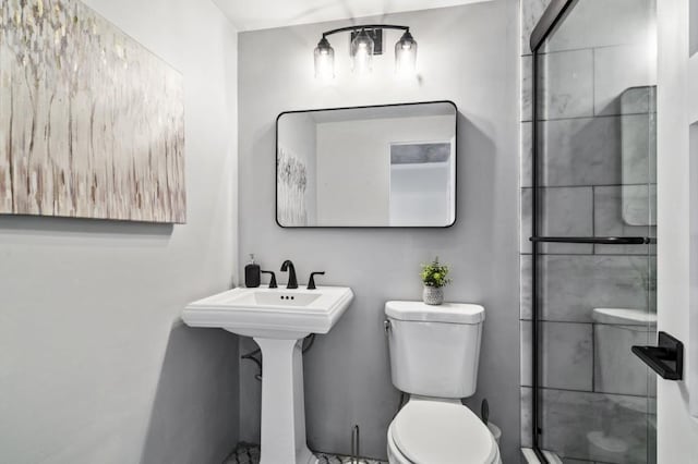 bathroom featuring an enclosed shower and toilet