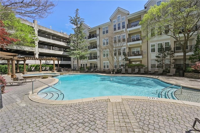 view of pool with a pergola and a patio