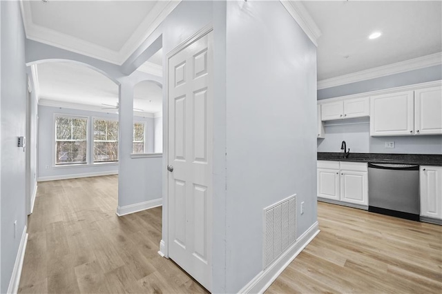 kitchen with light hardwood / wood-style floors, white cabinetry, and stainless steel dishwasher