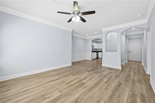 unfurnished living room featuring ceiling fan, light wood-type flooring, and ornamental molding