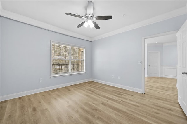 spare room featuring ceiling fan, ornamental molding, and light hardwood / wood-style floors