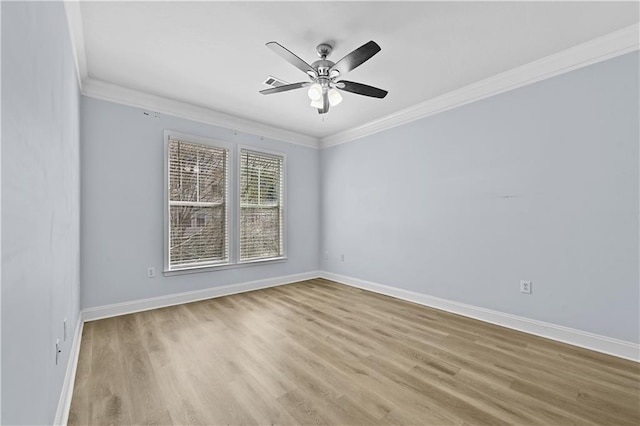 empty room with light hardwood / wood-style floors, ornamental molding, and ceiling fan