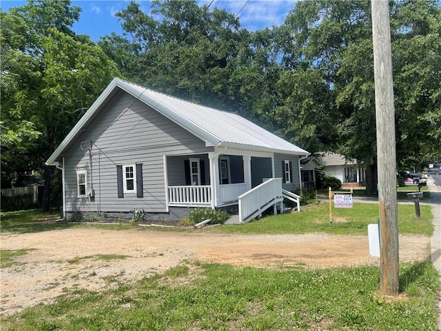 74 Martin Luther King Jr Dr, Winder, GA 30680 - view of front of house with covered porch, a front yard, and metal roof